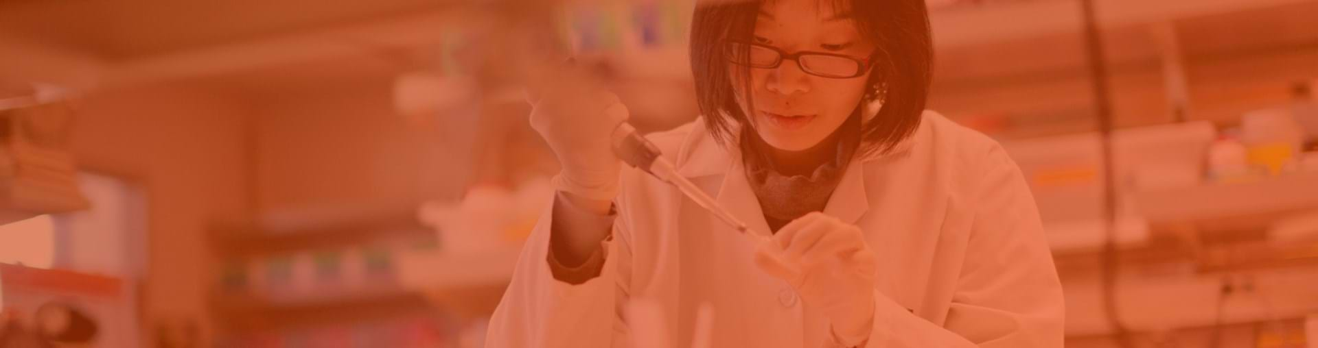 Scientist with a pipette in a biomedical laboratory