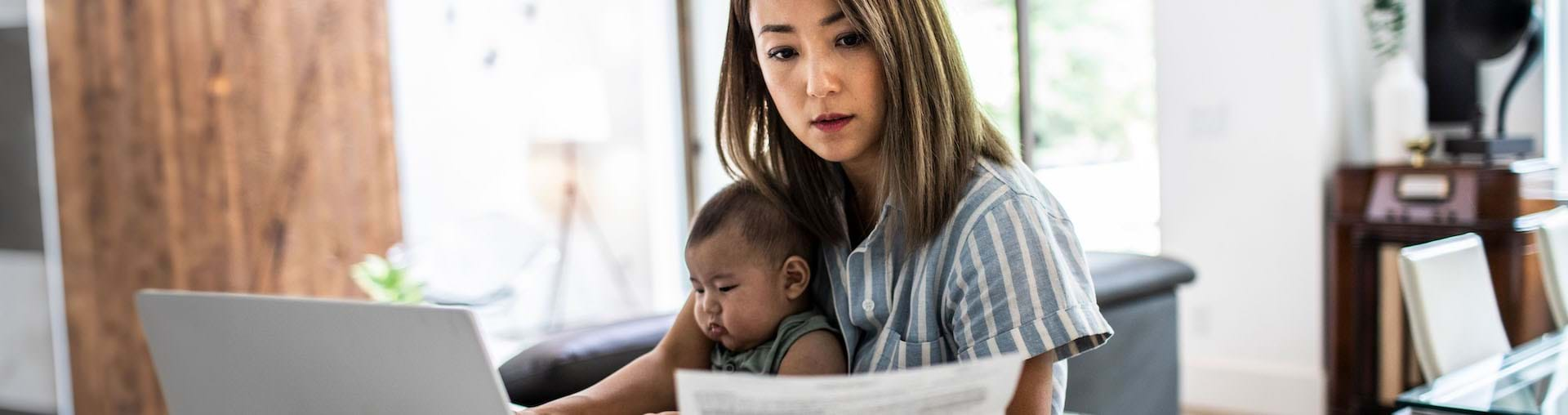 Woman working with a child in her lap