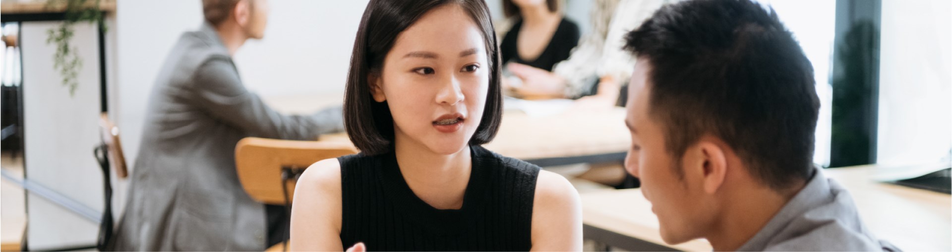 man and woman talking in office